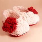 White baby bootie with red ..